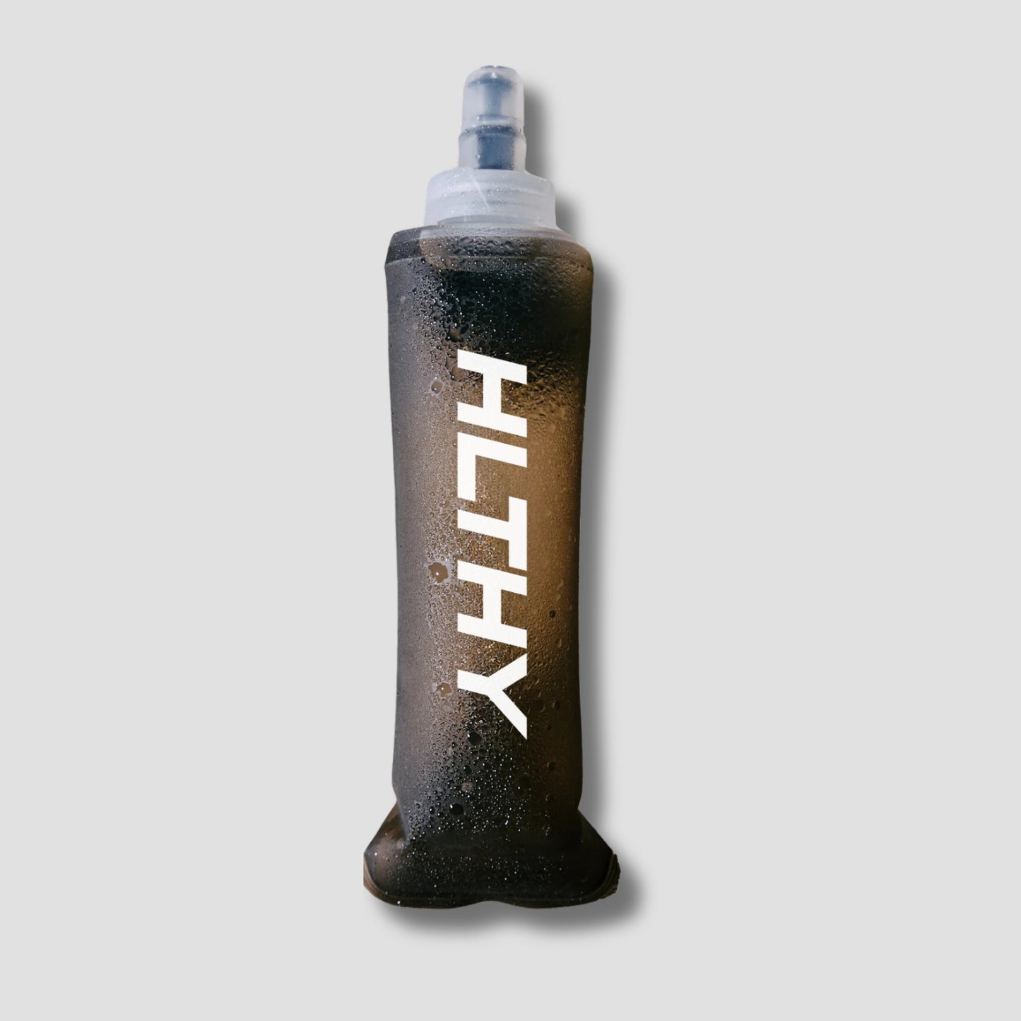 Flat lay of the HLTHY soft flask water bottle, showing its lightweight, flexible material and durable construction for long-term use