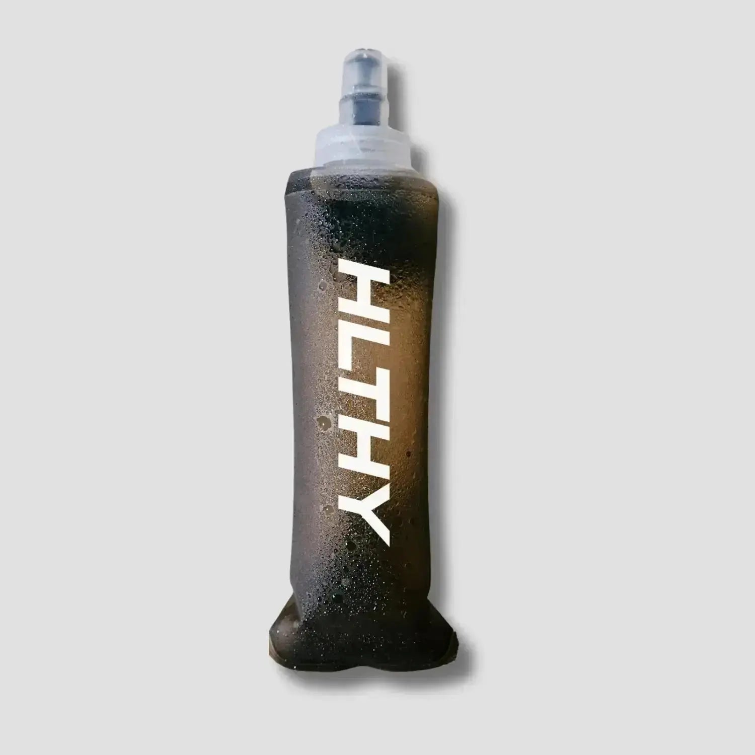 Flat lay of the HLTHY soft flask water bottle, showing its lightweight, flexible material and durable construction for long-term use