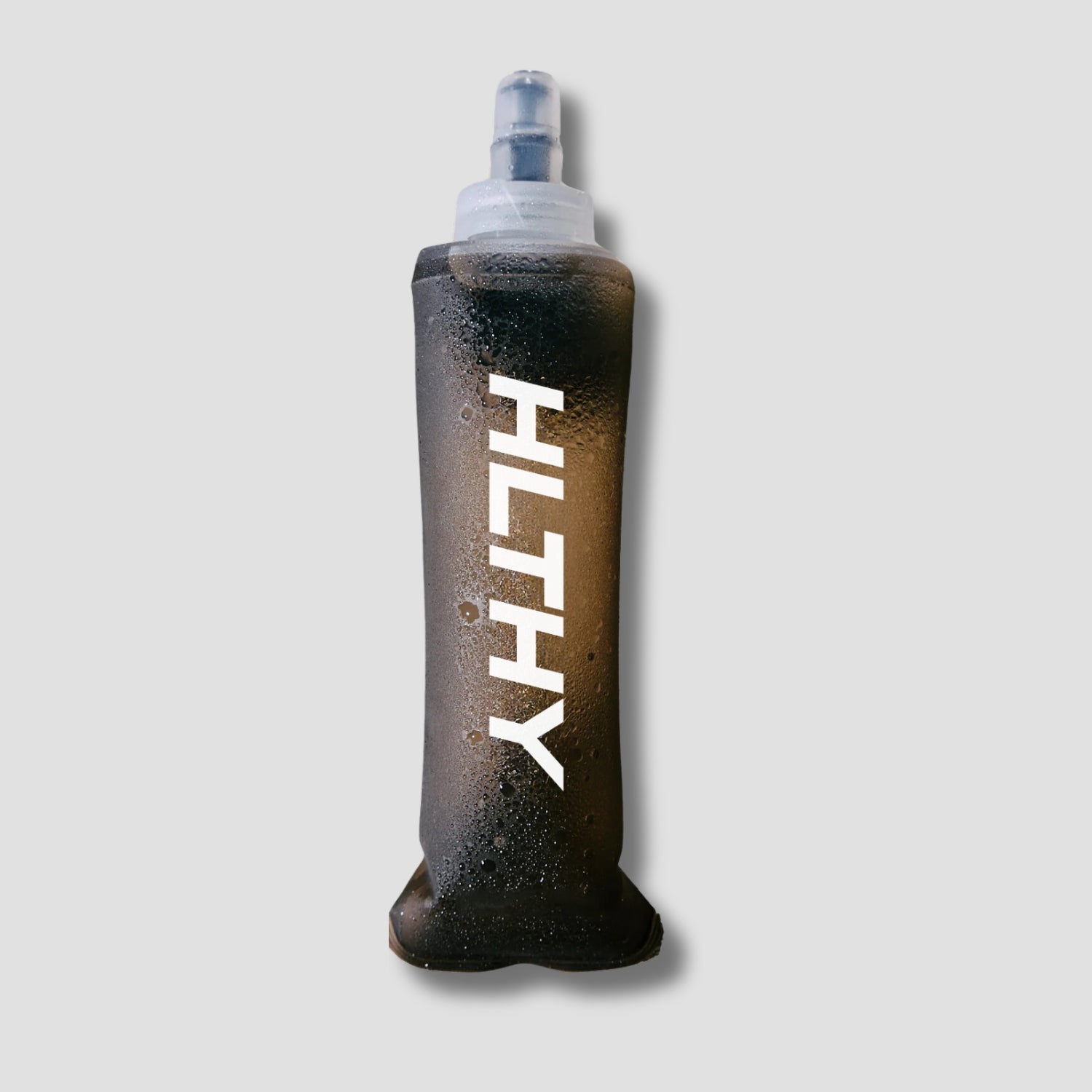 Flat lay of the HLTHY soft flask water bottle, showing its lightweight, flexible material and durable construction for long-term use